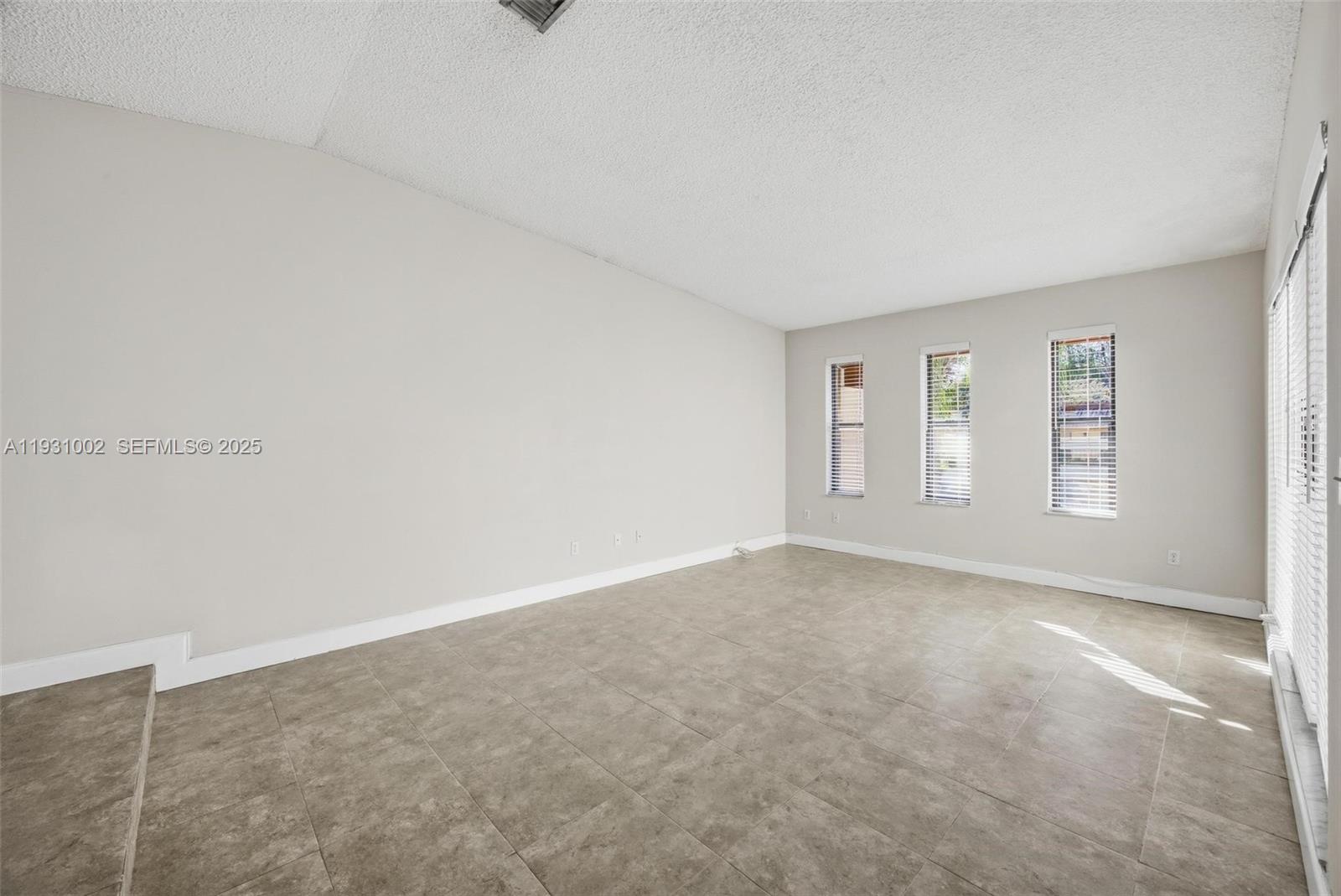 11731 Southwest 112th Terrace Miami, FL 33186 - Photo 7 of 41 a view of an empty room with windows