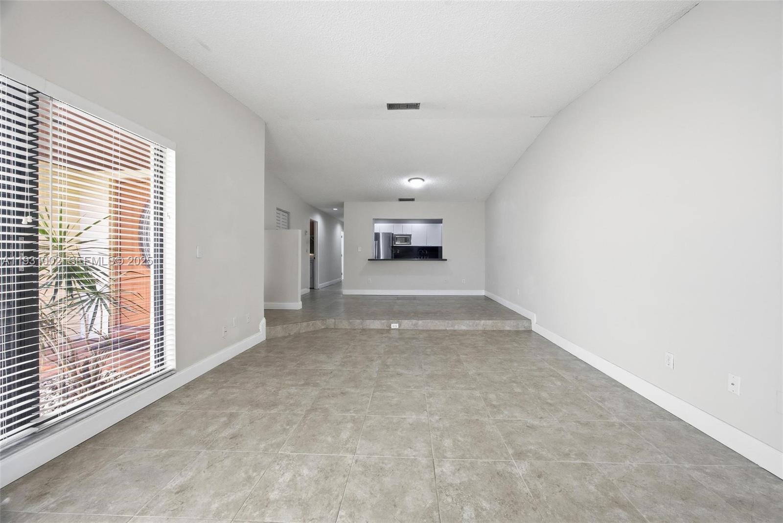 11731 Southwest 112th Terrace Miami, FL 33186 - Photo 10 of 41 a view of a livingroom with an empty space and a fireplace