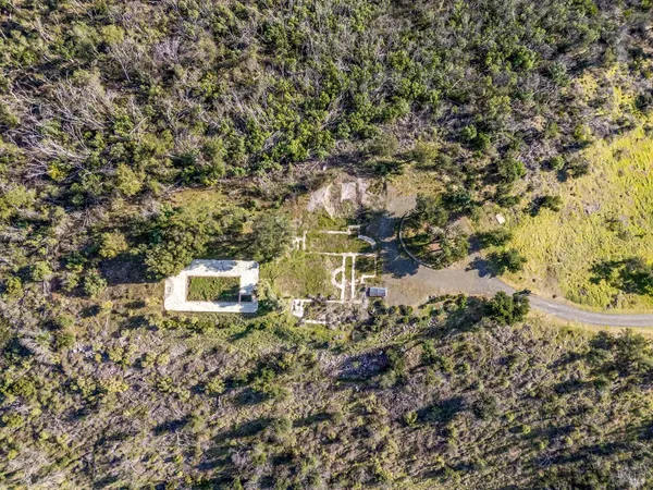 a aerial view of a house with yard and outdoor seating