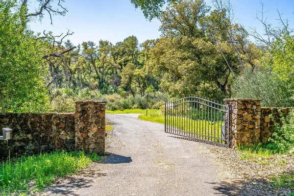 a view of a fence and trees
