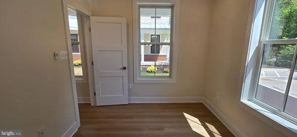 a view of an entryway with wooden floor and windows
