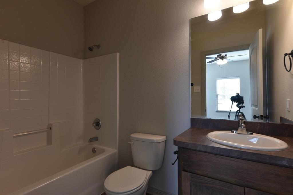 101 Capps Street, Unit B Rio Vista, TX 76093 - Photo 12 of 17 a bathroom with a sink a toilet and shower