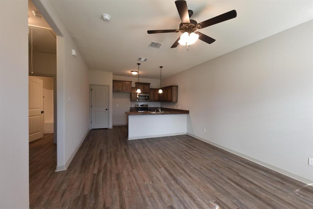 101 Capps Street, Unit B Rio Vista, TX 76093 - Photo 16 of 17 a view of a kitchen with a sink and a refrigerator