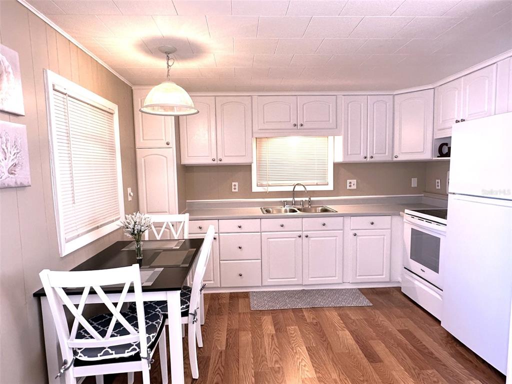 1600 Old Coachman Rd., Unit 816 Clearwater, FL 33765 - Photo 14 of 26 a kitchen with stainless steel appliances a stove a sink and a refrigerator