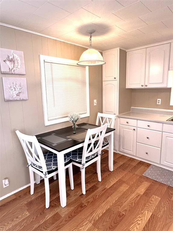 1600 Old Coachman Rd., Unit 816 Clearwater, FL 33765 - Photo 15 of 26 a view of a dining room with furniture and wooden floor