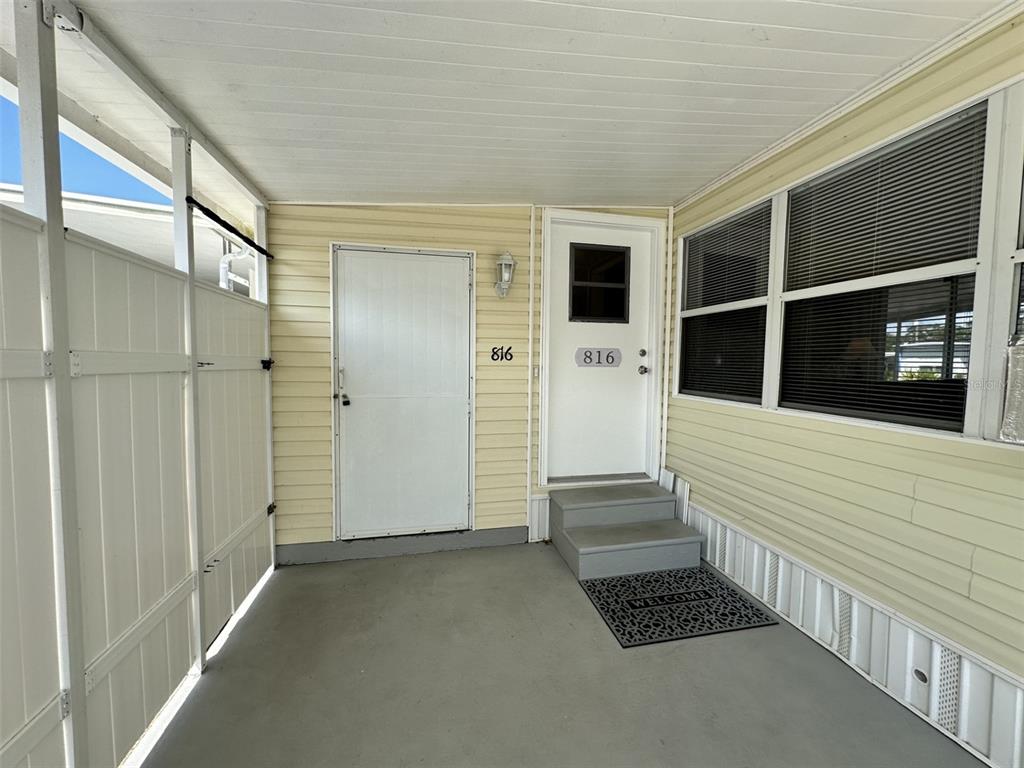 1600 Old Coachman Rd., Unit 816 Clearwater, FL 33765 - Photo 3 of 26 a view of a porch with wooden floor and a window