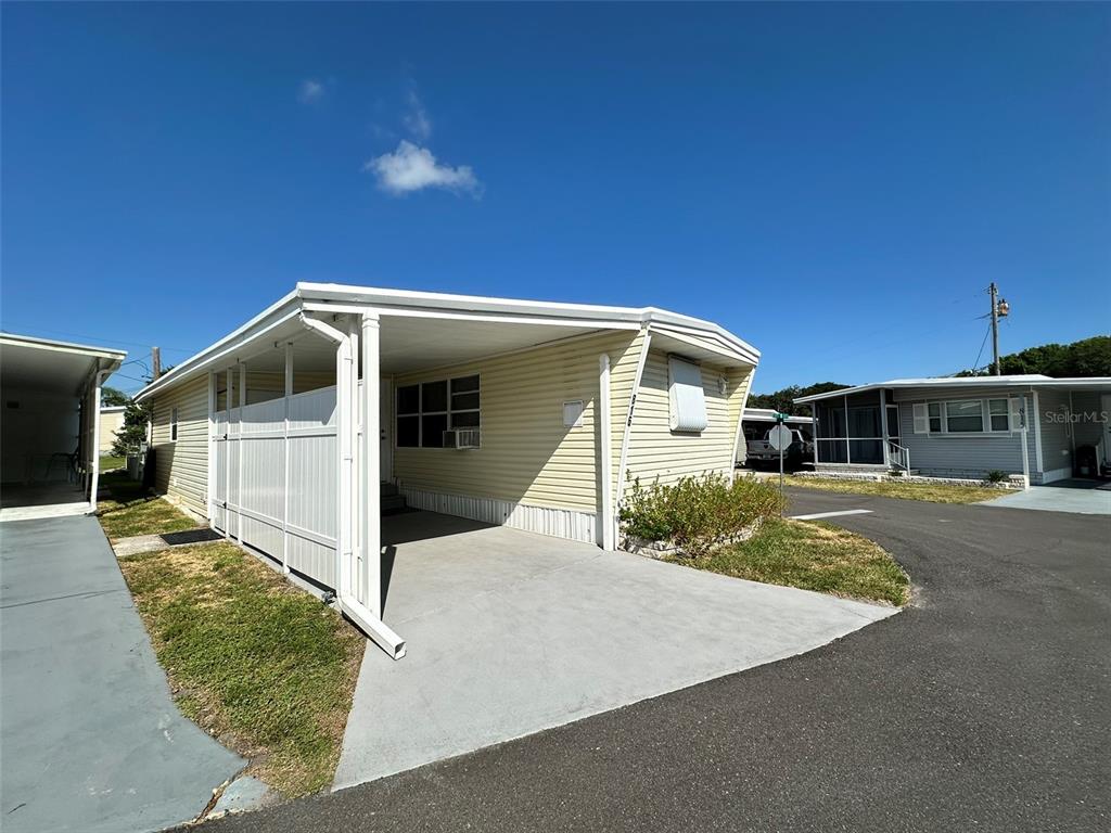 1600 Old Coachman Rd., Unit 816 Clearwater, FL 33765 - Photo 4 of 26 a front view of a house with a yard