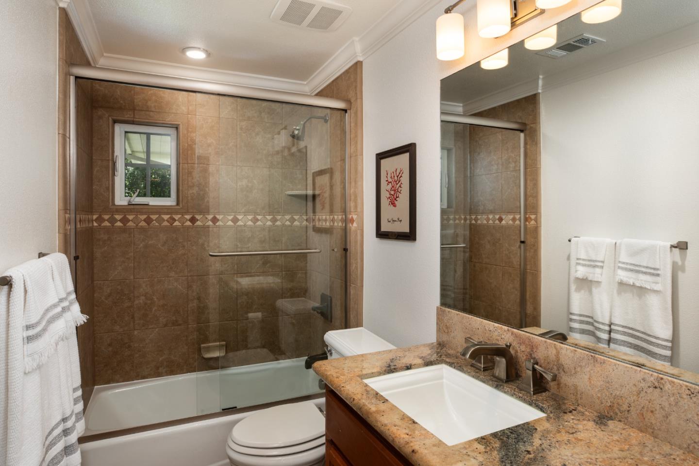 63 Ridge Court Woodside, CA 94062 - Photo 18 of 31 a bathroom with a sink a toilet a mirror and shower