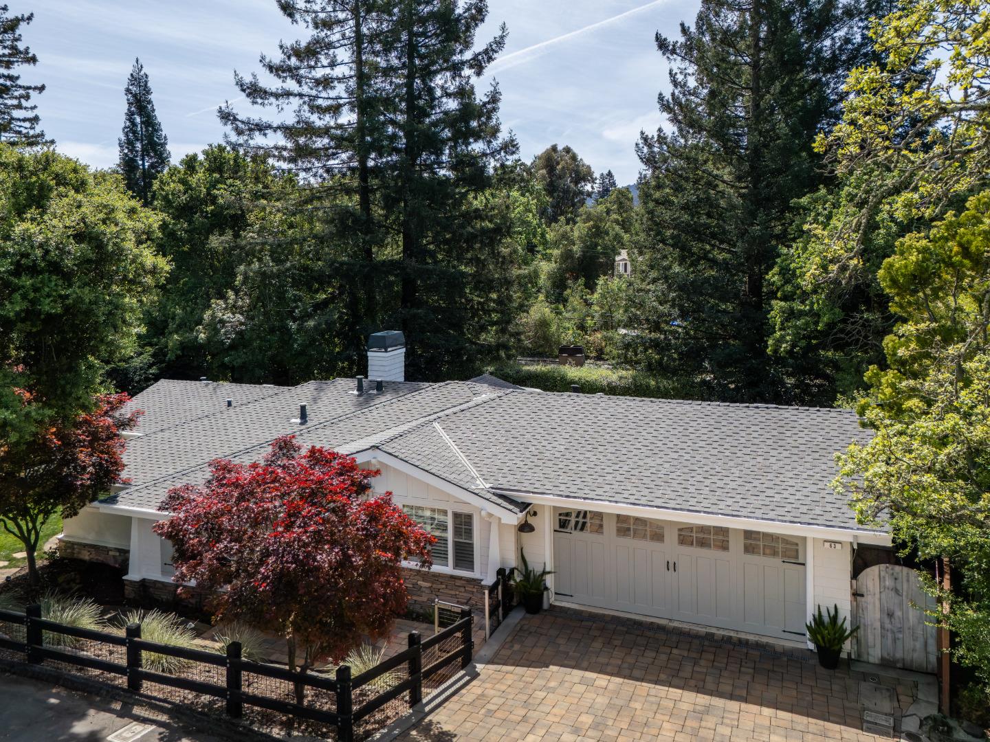 63 Ridge Court Woodside, CA 94062 - Photo 2 of 31 a terrace with a table and chairs under an umbrella