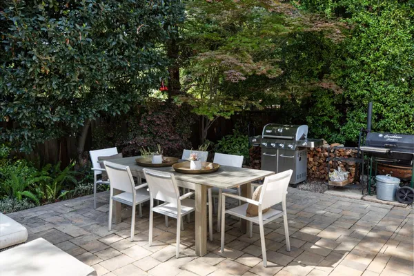 a view of balcony with furniture and umbrella