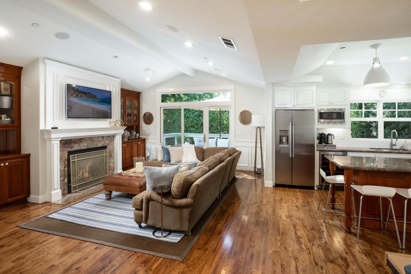 63 Ridge Court Woodside, CA 94062 - Photo 4 of 31 a living room with furniture a flat screen tv and a fireplace