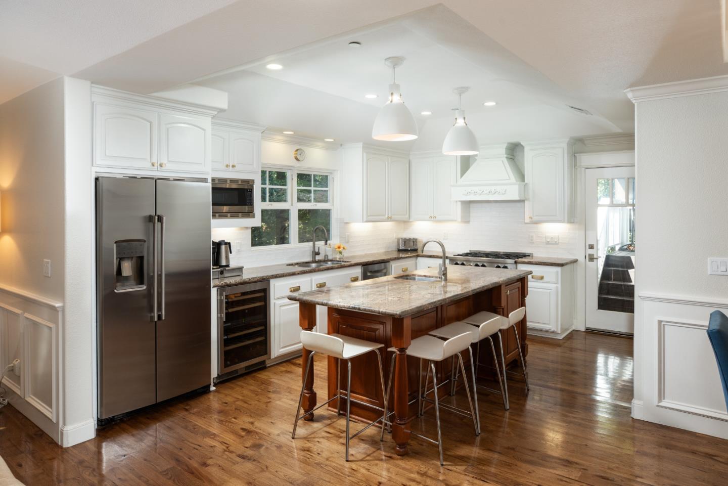 63 Ridge Court Woodside, CA 94062 - Photo 8 of 31 a kitchen with kitchen island granite countertop a center island stainless steel appliances cabinets and wooden floor