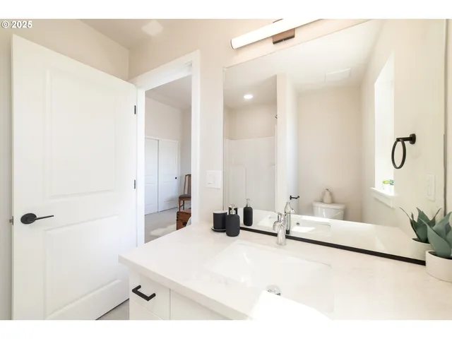 a bedroom with a bed and a mirror