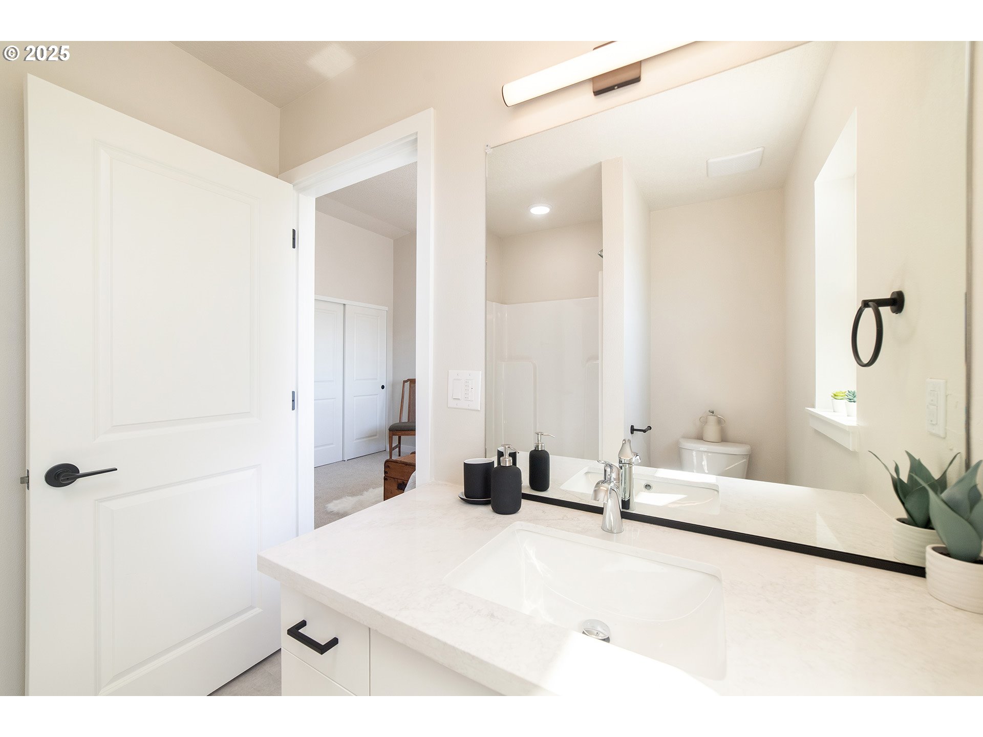 1671 Southeast Sherrett Street Portland, OR 97202 - Photo 11 of 16 a bedroom with a bed and a mirror