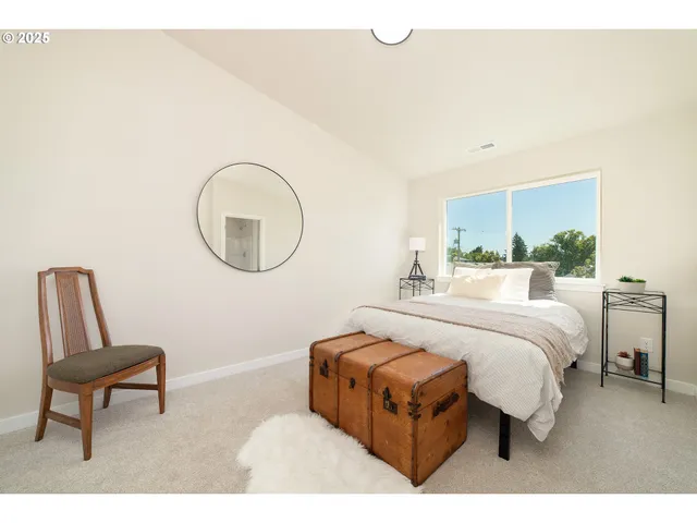 a living room with a bed furniture and a window
