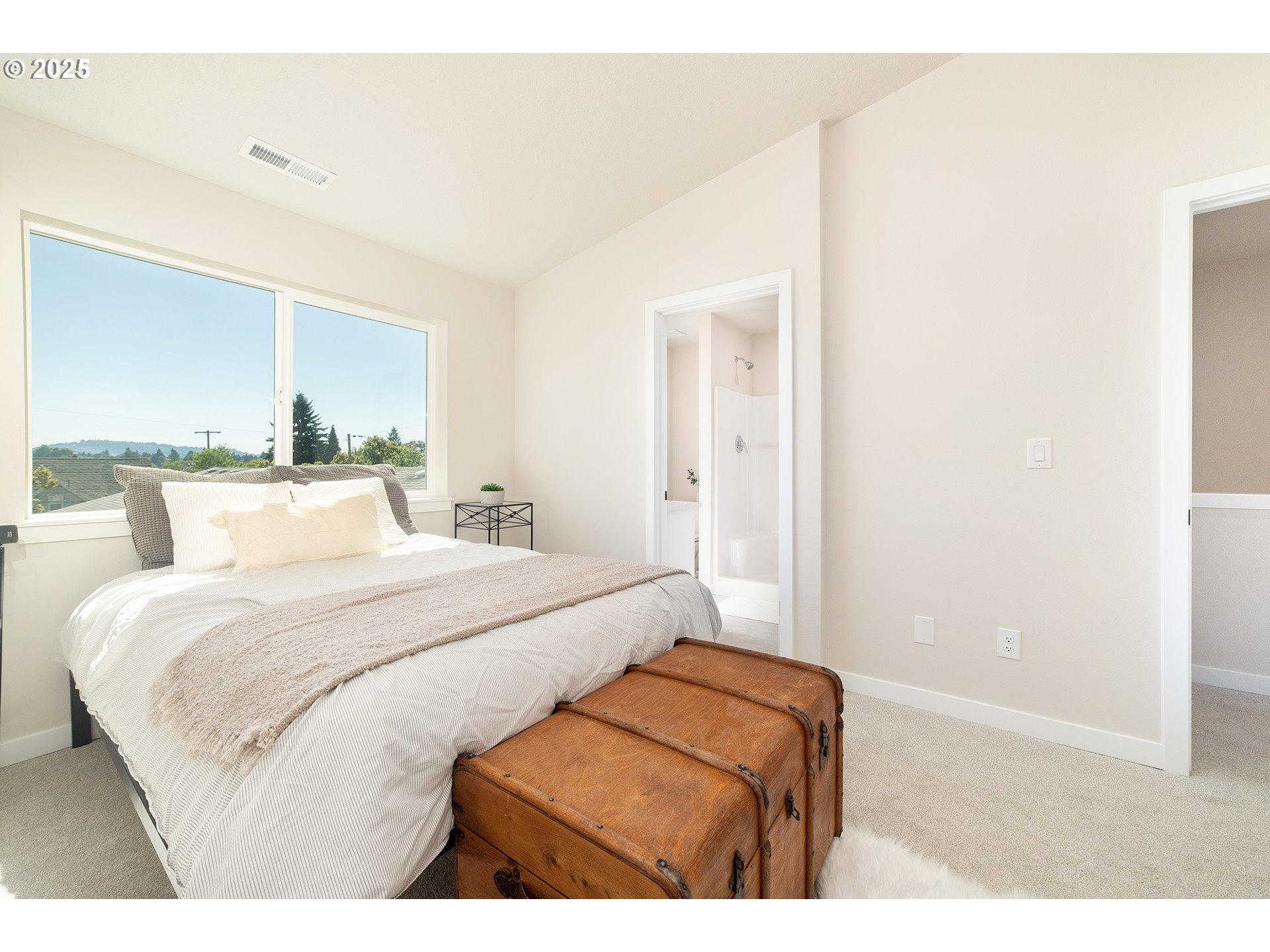 1671 Southeast Sherrett Street Portland, OR 97202 - Photo 9 of 16 a bedroom with a bed and a night stand