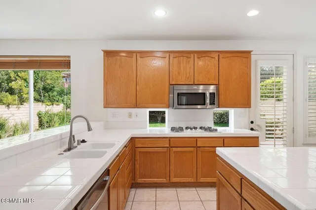 a kitchen with a sink stove and microwave