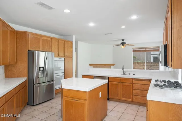 a kitchen with a sink stove and refrigerator