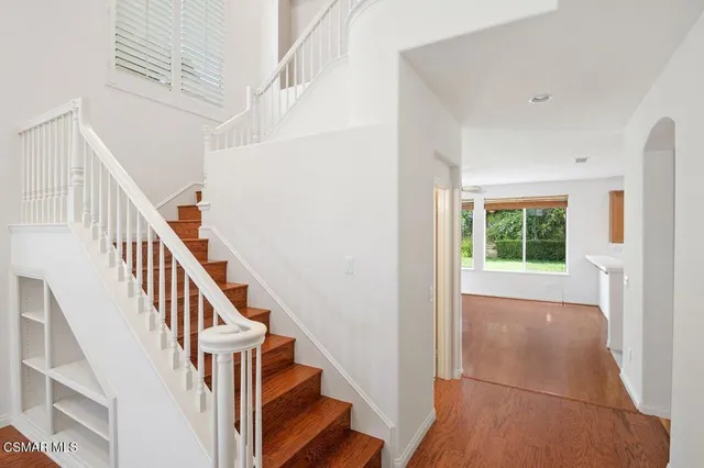 a view of entryway with wooden floor and stairs