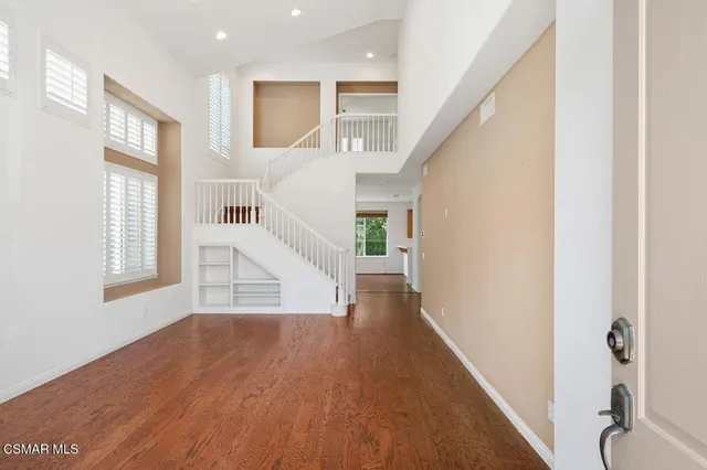a view of entryway with wooden floor and stairs