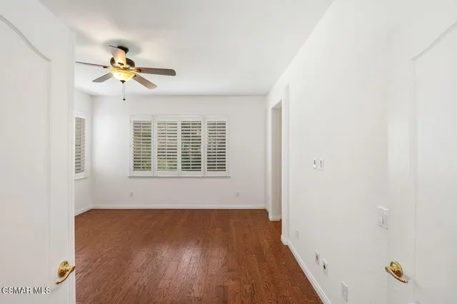 a view of a room with wooden floor and windows