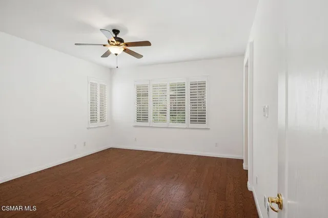a view of a livingroom with a ceiling fan and window