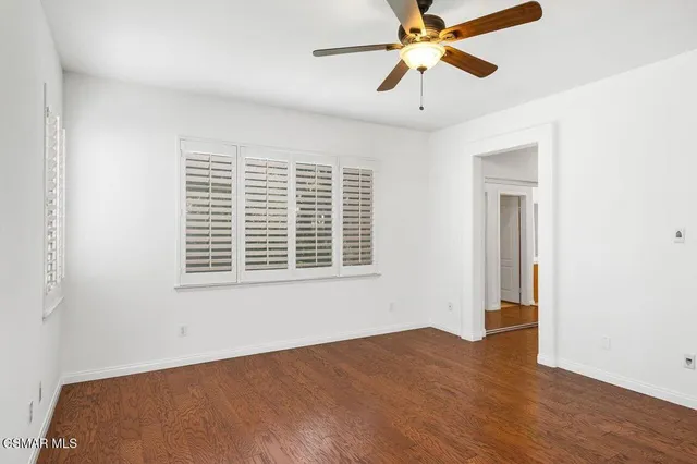 a view of a room with a ceiling fan and a window