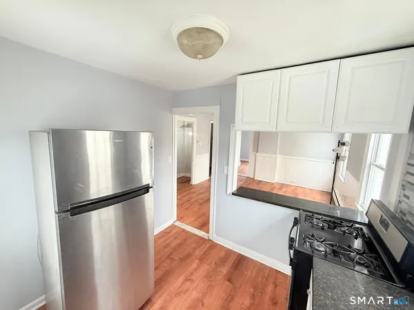 a view of a room with wooden floor