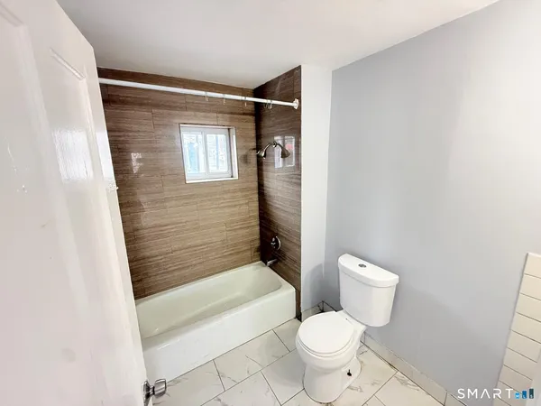 a bathroom with a toilet and a bathtub