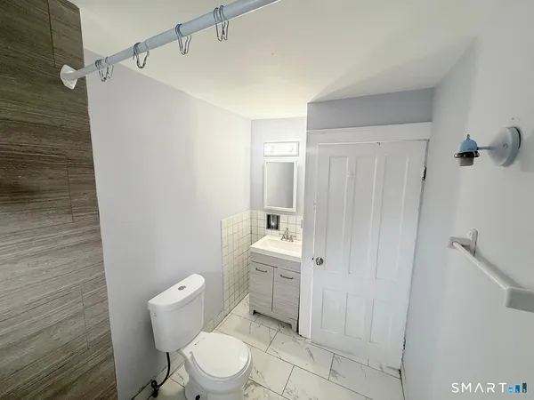 a white toilet sitting next to a bathroom sink