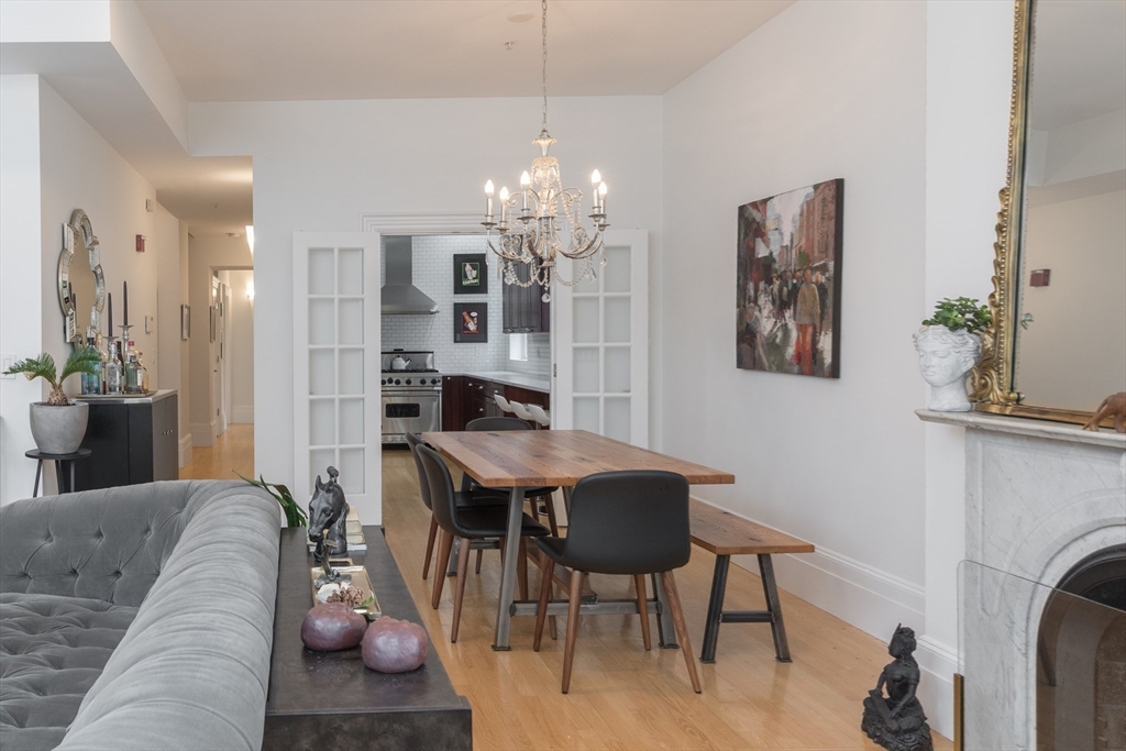 41 Worcester Street, Unit 2 Boston, MA 02118 - Photo 12 of 27 a living room with furniture a chandelier and a dining table