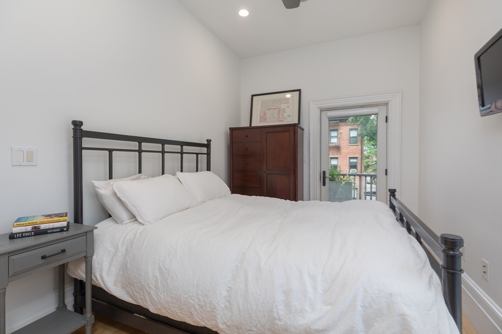 41 Worcester Street, Unit 2 Boston, MA 02118 - Photo 13 of 27 a bedroom with a bed and a tv on table