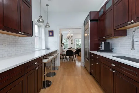 a kitchen with stainless steel appliances granite countertop wooden cabinets a stove top oven a sink and dishwasher