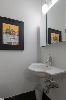 a bathroom with a sink mirror and toilet