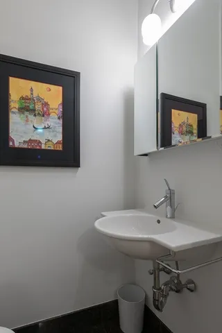 a bathroom with a sink mirror and toilet