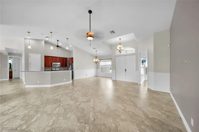 a view of a kitchen with a sink and a chandelier