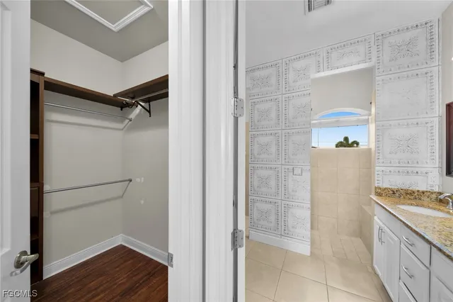 a bathroom with a granite countertop shower a sink and a mirror