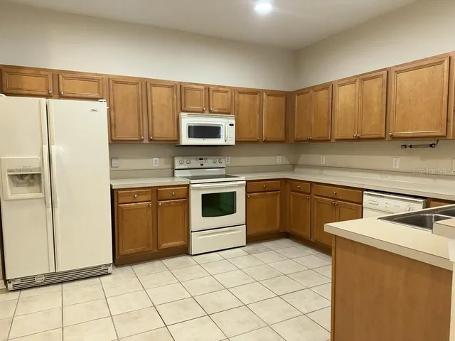 a kitchen with cabinets stainless steel appliances and a sink