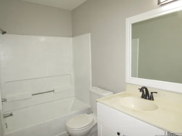a bathroom with a sink a toilet and vanity