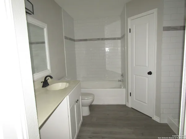 a bathroom with a sink a toilet and a bathtub