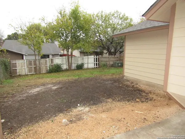 a view of a house with a yard and garage