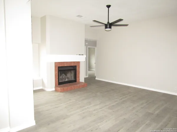 a view of an empty room with a fireplace