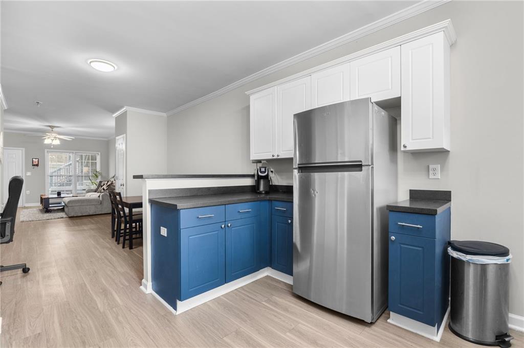3675 Peachtree Road Northeast, Unit 45 Atlanta, GA 30319 - Photo 13 of 42 a kitchen with stainless steel appliances a refrigerator and wooden floor