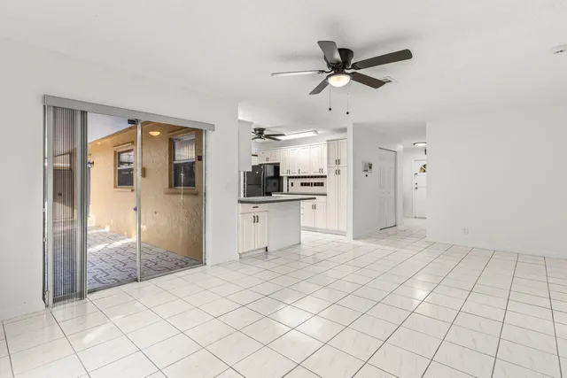 a view of a kitchen with a sink and a refrigerator