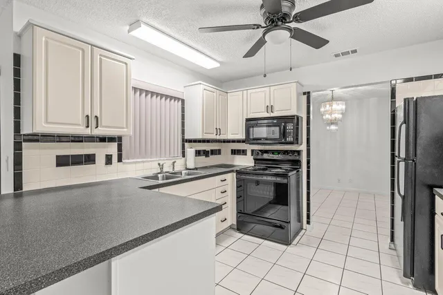 a kitchen with stainless steel appliances a stove a sink and a refrigerator