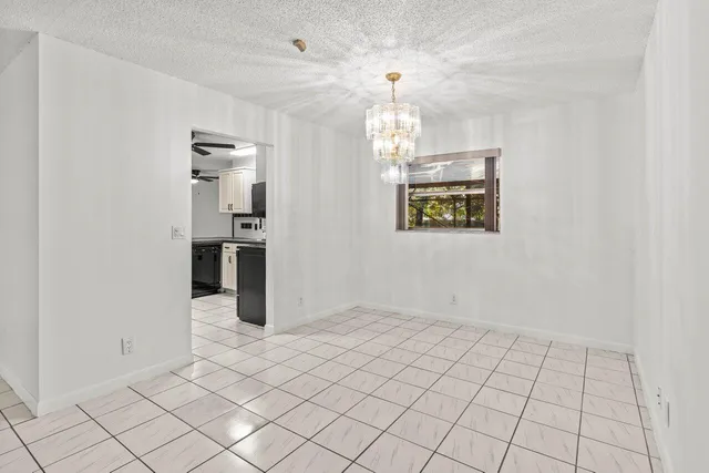 an empty room with kitchen view and appliances