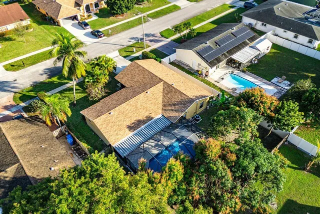 an aerial view of a house with a yard
