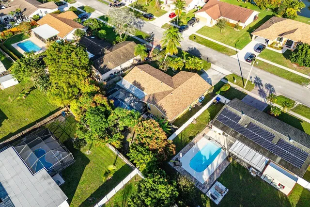 an aerial view of a house with a yard and garden