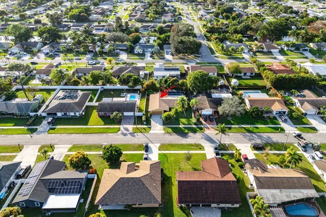 an aerial view of residential houses and car parked on street side