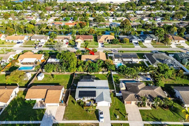 an aerial view of residential houses with outdoor space and street view